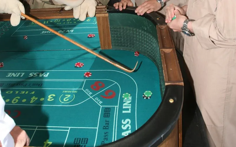 Craps table felt showing the Pass Line, field area and chips