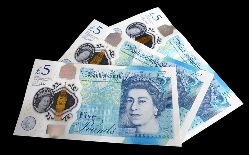 Four Bank of England polymer five pound notes fanned out